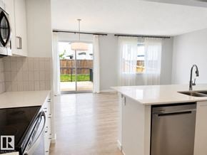 Edmonton apartment for rent - A kitchen with white cabinets and a stainless steel dishwasher.