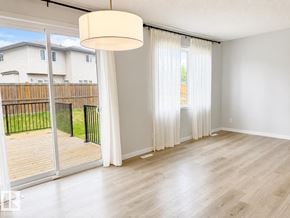 Edmonton apartment for rent - A room with a sliding glass door leading to a backyard.
