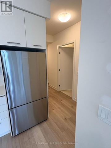 Grimsby (Grimsby Beach) condo for rent - A kitchen with a stainless steel refrigerator and wooden floors.