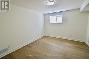 Toronto (L'amoreaux) apartment for rent - A room with a window and wooden flooring.