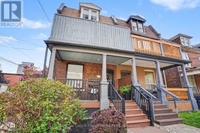 Toronto (Junction Area) apartment for rent - A house with a grey roof and a balcony with orange railings.