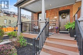 Toronto (Junction Area) apartment for rent - A small porch with a black railing and a wooden floor.