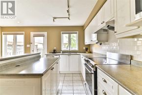 Oakville (Ro River Oaks) apartment for rent - A kitchen with a large island and stainless steel appliances.