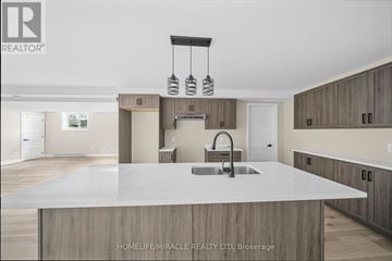 Cornwall apartment for rent - A modern kitchen with a large island and wooden cabinets.
