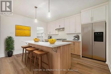 Casselman duplex for rent - A kitchen with wooden cabinets and a white countertop.