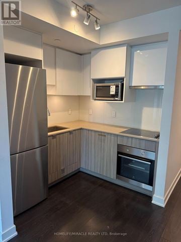 Toronto (Mount Pleasant West) condo for rent - A modern kitchen with a stainless steel refrigerator and microwave.