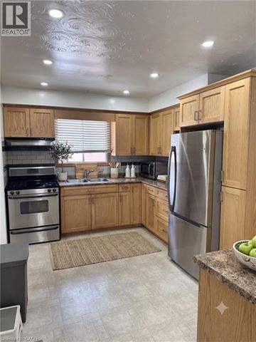 Cambridge apartment for rent - A kitchen with wooden cabinets and stainless steel appliances.