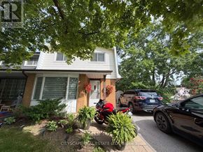 Mississauga (Erin Mills) apartment for rent - A house with a red door and a tree in front.