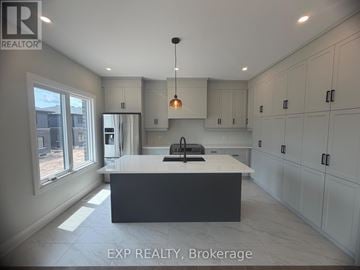 Niagara Falls (Marineland) apartment for rent - A modern kitchen with white cabinets and a large island.