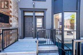 Whitchurch-Stouffville (Stouffville) apartment for rent - The image shows the front of a building with a dark grey door and a small window above it.
