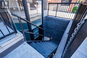 Whitchurch-Stouffville (Stouffville) apartment for rent - A staircase with a metal railing and steps leading down to a darker area.