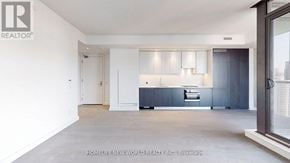 Toronto (Church-Yonge Corridor) condo for rent - A modern kitchen with a large island and a view of the city.
