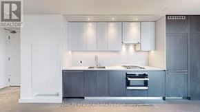 Toronto (Church-Yonge Corridor) condo for rent - A modern kitchen with a sink, stove, and cabinets.