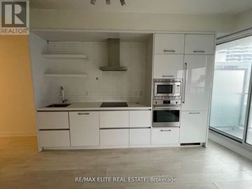 Toronto (Mount Pleasant West) condo for rent - A modern kitchen with white cabinets and appliances.