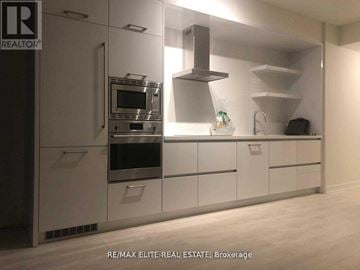 Toronto (Mount Pleasant West) condo for rent - A modern kitchen with a stainless steel oven and microwave.