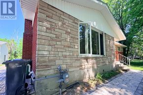 Ottawa apartment for rent - A house with a brick wall and a window is for sale.