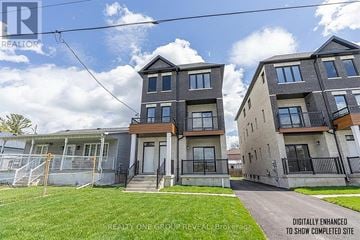 Oshawa (Vanier) apartment for rent - A row of modern townhouses with a grassy front yard.
