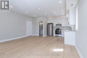 Oshawa (Vanier) triplex for rent - A spacious kitchen with stainless steel appliances and white cabinetry.