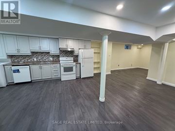 Toronto (Rouge) apartment for rent - A kitchen with white appliances and cabinets is shown in this image.