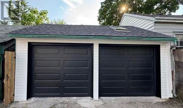 Toronto (Trinity-Bellwoods) apartment for rent - A black double garage door is closed.
