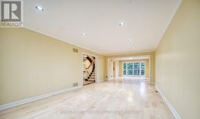 Toronto (Banbury-Don Mills) apartment for rent - A spacious room with wooden flooring and a staircase in the background.