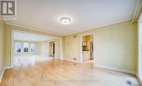 Toronto (Banbury-Don Mills) apartment for rent - A spacious room with wooden flooring and a ceiling light.