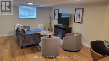 Toronto (High Park-Swansea) apartment for rent - A living room with a grey couch, a brown chair, and a television.