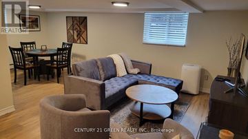 Toronto (High Park-Swansea) apartment for rent - A living room with a grey couch and a round table.