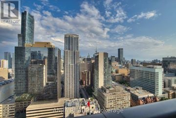 Toronto (Bay Street Corridor) condo for rent - A cityscape with tall buildings and a clear sky.
