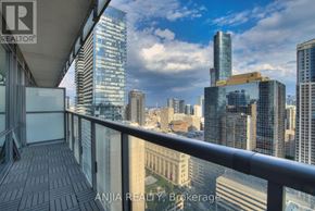Toronto (Bay Street Corridor) condo for rent - A balcony overlooks a cityscape with tall buildings.