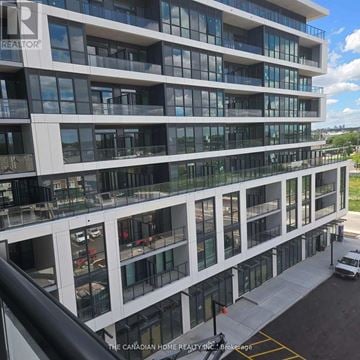 Toronto (Clairlea-Birchmount) condo for rent - A modern multi-story building with a glass facade and balconies.