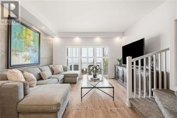Hamilton (Hamilton Beach) townhouse for rent - A living room with a grey sofa, a coffee table, and a painting on the wall.