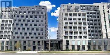 Toronto (Clanton Park) condo for rent - Two large buildings stand side by side with a blue sky in the background.