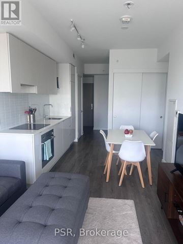 Toronto (Mount Pleasant West) condo for rent - A modern kitchen with a dining table set for two.