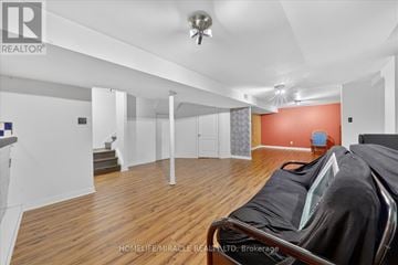 Ajax (Central) apartment for rent - A living room with a couch and a ceiling fan.