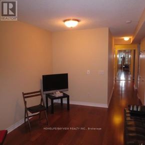 Toronto (Bay Street Corridor) condo for rent - A living room with a television and a chair.