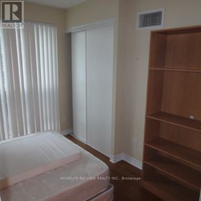 Toronto (Bay Street Corridor) condo for rent - A room with a bed, a closet, and a shelf.
