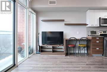 Waterloo condo for rent - A living room with a television and two chairs.