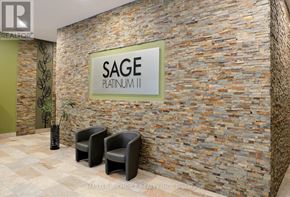 Waterloo condo for rent - Two black chairs are placed in front of a stone wall with a sign that says SAGE PLATINUM 11.