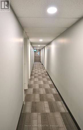 Waterloo condo for rent - A long hallway with a checkered floor and white walls.