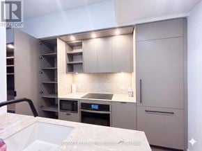 Toronto (Church-Yonge Corridor) townhouse for rent - A modern kitchen with a sink, stove, and cabinets.