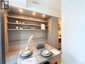 Toronto (Church-Yonge Corridor) townhouse for rent - A modern dining area with a laptop on the table.