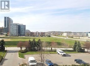 Richmond Hill (Langstaff) condo for rent - A real estate brokerage office is located in a parking lot with a building in the background.