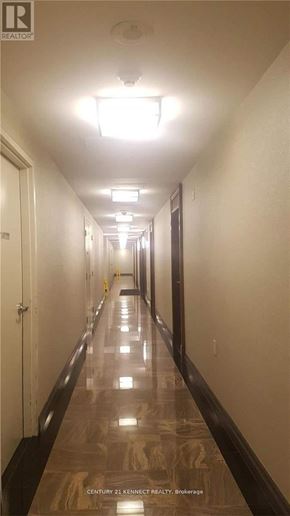 Richmond Hill (Langstaff) condo for rent - A long hallway with lights on the ceiling and doors on the left.