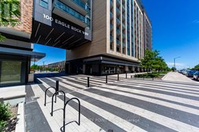 Vaughan condo for rent - A modern building with the sign "100 Eagle Rock Way" is shown.