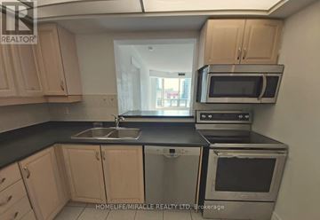 Toronto (Willowdale West) condo for rent - A kitchen with a sink, stove, and microwave.