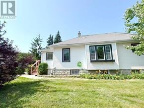 St. Catharines (E. Chester) apartment for rent - A white house with a green logo on the front.