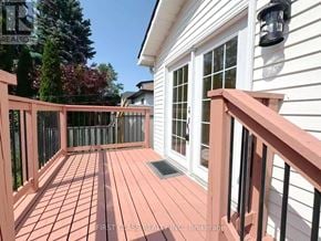 St. Catharines (E. Chester) apartment for rent - A wooden deck with a black railing and a window.