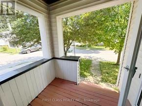 St. Catharines (E. Chester) apartment for rent - A balcony with a view of a tree and a car.