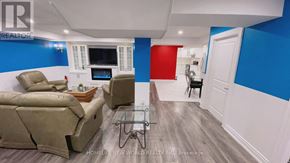 Richmond Hill (Devonsleigh) apartment for rent - A living room with a couch, chair, and television.
